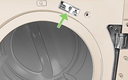 Model tag near a laundry appliance door opening